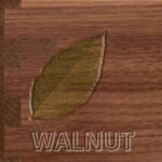 A walnut leaf engraved on a piece of wood.